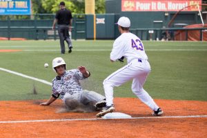 Tanner Boyzuick slides into the third in Argyle’s win over Abilene Wylie last June. The Eagles are looking to defend their state championship this season. (Photo by Caleb Miles)