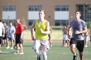 Andrew Hopkins (yellow shirt) of Marcus High School takes part in one of fifty 40-yard dashes in what coaches call the "final exam" of summer workouts on July 29.