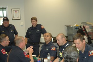 Firefighter and chaplain Jeff Burks (lower right) talks with fellow Flower Mound firefighters and police officers at a recent first responders appreciation luncheon (Photo Courtesy: FMCC)