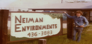 Bill Neiman stands by the sign at his former business in Flower Mound (Photo Courtesy: Bill Neiman).