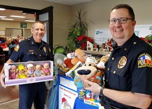 Flower Mound Police Chief Andy Kancel and Assistant Chief Wendell Mitchell collect toys for the Santa Cops program.