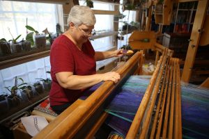 Master Weaver Gloria Haefner-Gatti of Double Oak at her giant loom. (Photo by Foust Photography)