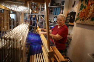 Master Weaver Gloria Haefner-Gatti of Double Oak at her giant loom. (Photo by Foust Photography)