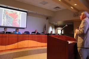 Highland Village City Manager Mike Leavitt informs the council about BLM plans to lease the area on the map (shown in red) for gas drilling. (Photo by Steve Southwell, Lewisville Texan Journal)