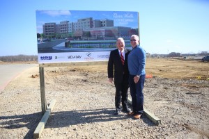 New Era Partners Scott Tarwater, president and CEO with Tim Lavender, founder and principal, with the rendering of Flower Mound’s first hotel, The Courtyard of Marriott Hotels at the River Walk, being built by developer New Era Hotels and Resorts. (Photo by Foust Photography)