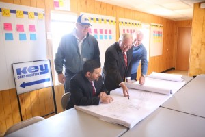 Discussing plans for Flower Mound’s first hotel are: Key Construction Superintendent Richard Harp; New Era Partners Vice President and Project Manager Brad McCafferty, seated; Scott Tarwater and Tim Lavender, president/CEO and founder/principal of New Era Partners, respectively. (Photo by Foust Photography)