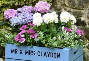 Crates, recycled or purchased, can be painted and personalized to create a colorful, unique planter for flowers and edibles. (Photo credit: courtesy of PersonalizedCrates.com)