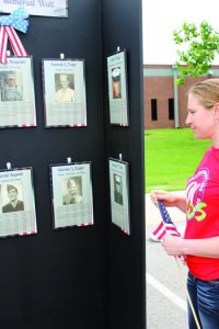 Mehgan DeProspero of Flower Mound had a difficult time expressing the feelings the Memorial Wall evoked. She said quietly that she was “just taking it all in.” Photo by Dru Murray.