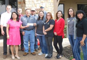 Diana Corona, RSVP Executive Director, and Rhett Hubbard, RSVP board member, with Grande employees. (Photo: Grande Communications)