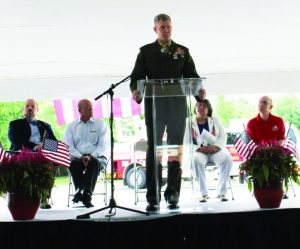 Colonel Paul T. Patrick delivers a keynote address. Sitting behind him are (left to right) Mayor Pro Tem Kevin Bryant, Flower Mound Council Member Bryan Webb, Ret. Lt. Colonel Ginger Simonson, and Flower Mound Fire Department Chaplain Russ McNamer. Photo by Dru Murray.