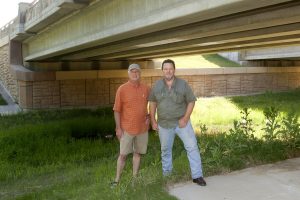 James Lee and Mark Glover with the Cross Timbers Bat Initiative scout out a possible home for bats on South Garden Ridge Boulevard in Flower Mound. (Photo by Helen’s Photography) 