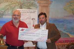 Tom Cibula of Christian Community Action accepts a $3,000 donation from Summit Club of Flower Mound president Claudio Forest.