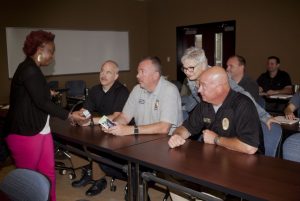 Tanesha Tyler-Carr (left) with the Dallas Chapter of the Alzheimer's Association trains members of the Highland Village Police Department how to recognize the signs of dementia and deal with the needs of people with the disease. (Photo by Helen’s Photography)