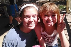 Avery Portz (left) with a new friend at a soccer clinic.