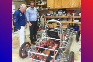 Astronaut Charlie Duke (left) learns more about Liberty’s solar car from Dr. Brent Dragoo on his visit to the school in April.