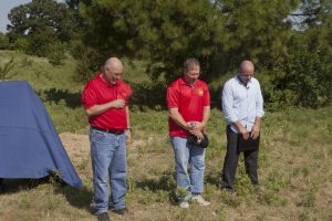 Delivering the invocation was veteran Mark Roy, center, with Jeff Ramsey, right, and Raul Lugo, left. Lugo is the father of Marine Lance Cpl. Jacob Lugo, the first Flower Mound soldier killed in action serving in Operation Iraqi Freedom on Aug. 24, 2004 at age 21. The first street in the Hawks Hill development was named in his honor.(Photo by Helen's Photography)