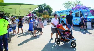 All ages of attendees at last year’s FloMo Food Truck Fest enjoyed the cornucopia of food offerings and other activities. (Photo courtesy of Margolis Photography, Flower Mound)