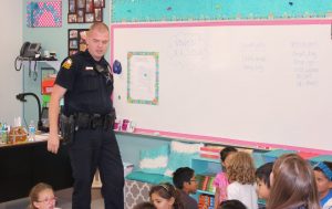 Flower Mound Police Officer Erik White talking to second graders in Sarah Strange's class on Career Day at Garden Ridge Elementary School in Flower Mound.