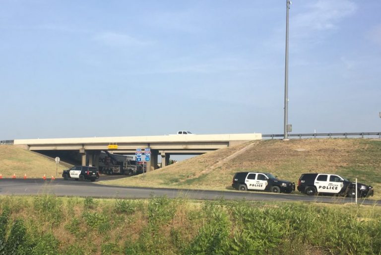 Truck crashes off I-35W bridge onto Crawford Road